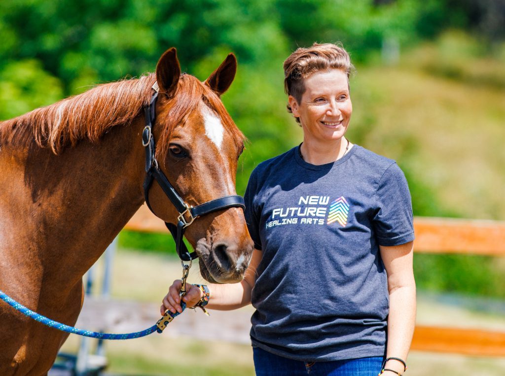 A photo of AJ smiling with her horse Luka