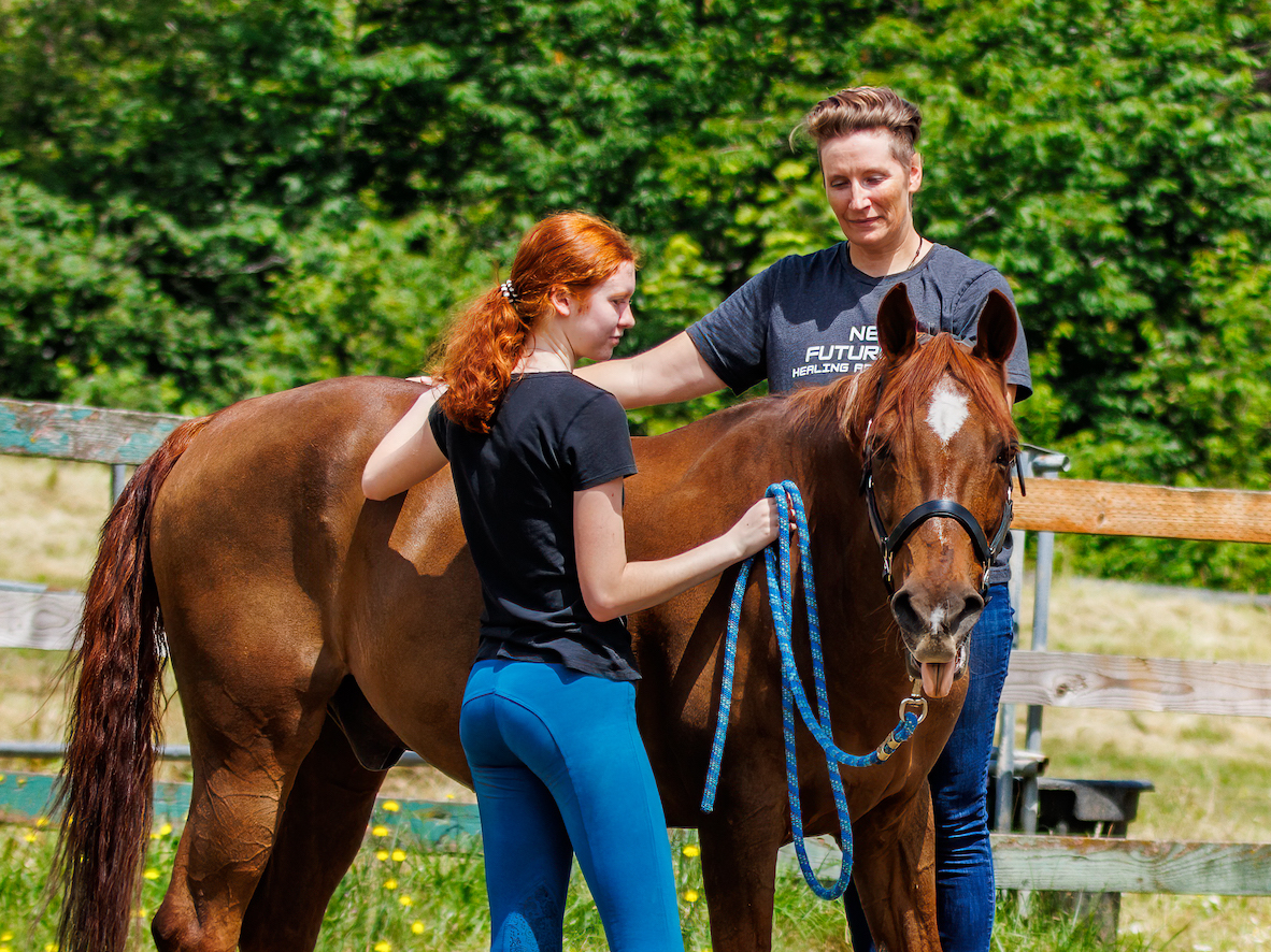 AJ is showing a redheaded teenager how to become more connected relationship with your horse